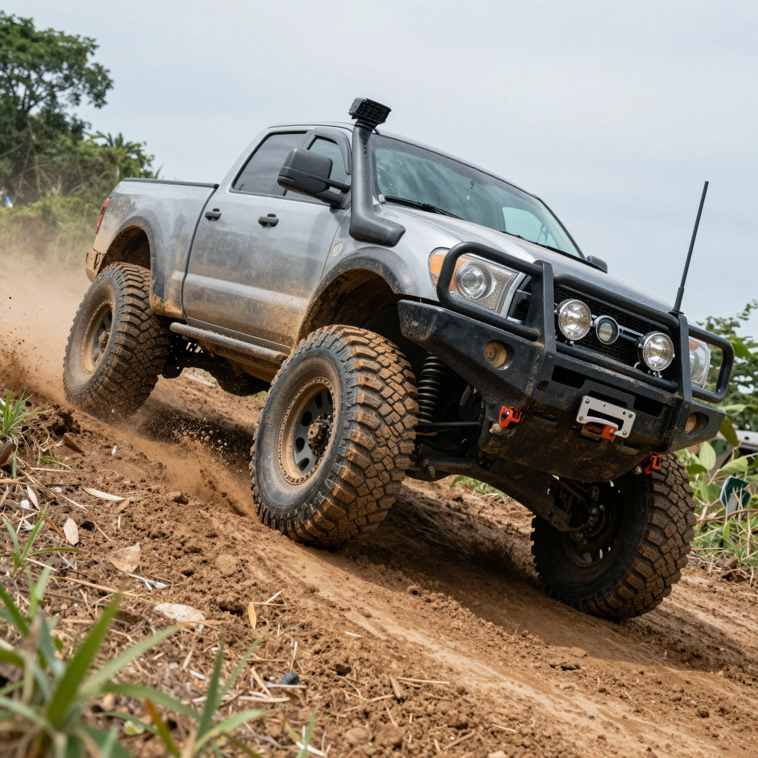 A modified 2WD truck conquering a steep, muddy incline
