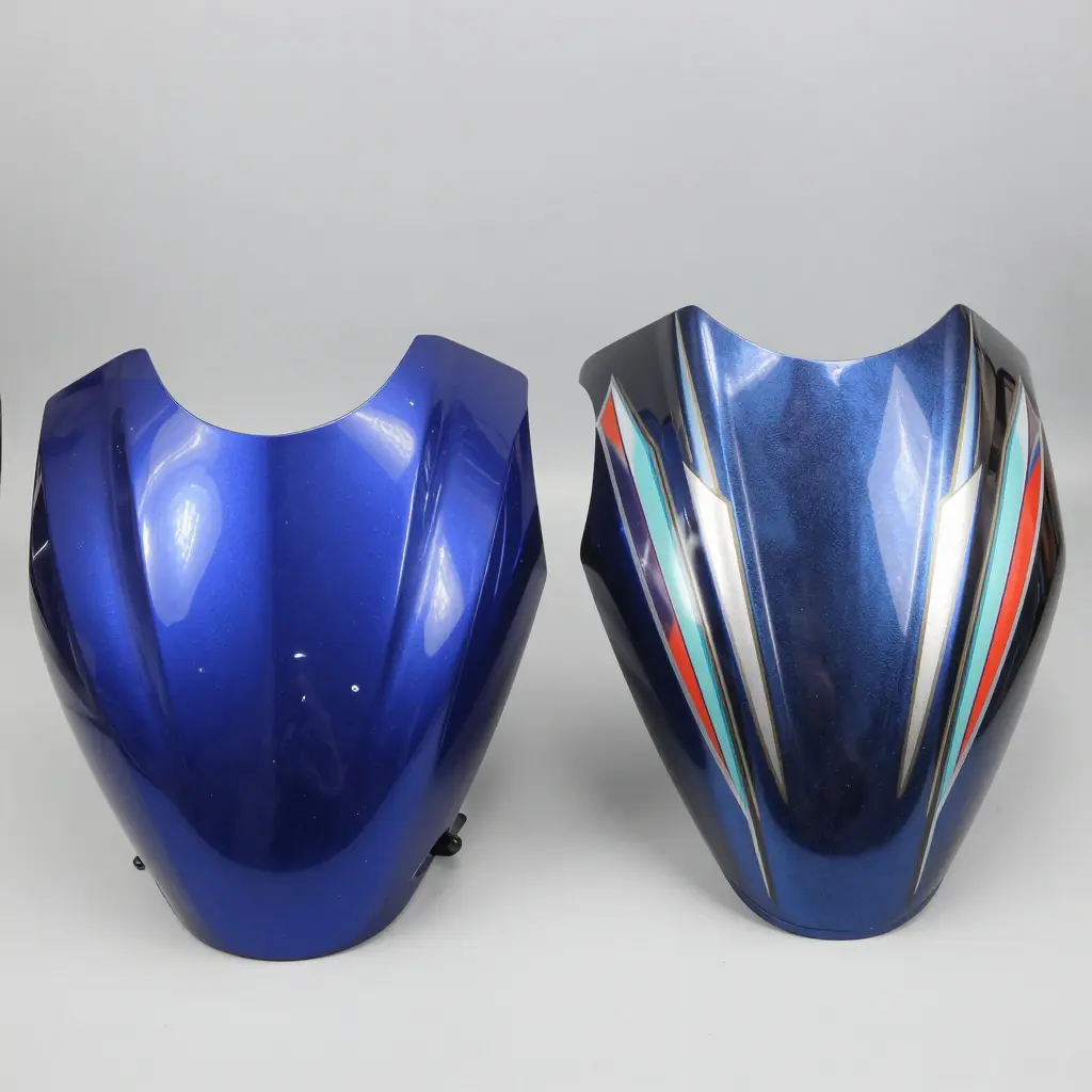 Side-by-side comparison of a glossy painted ABS fairing and a candy-painted fiberglass fairing showing finish quality