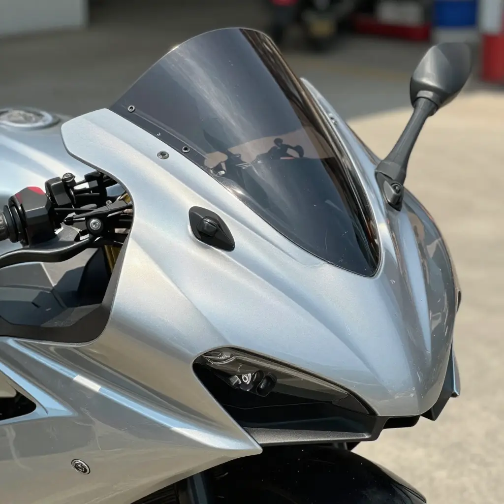 A motorcycle fairing half in direct sunlight and half in shade showing a subtle paint color mismatch